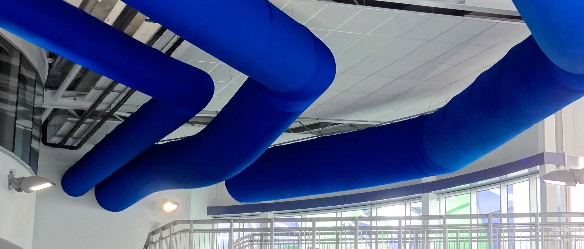 Blue fabric duct systems installed inside Greensborough indoor swimming pool, AU