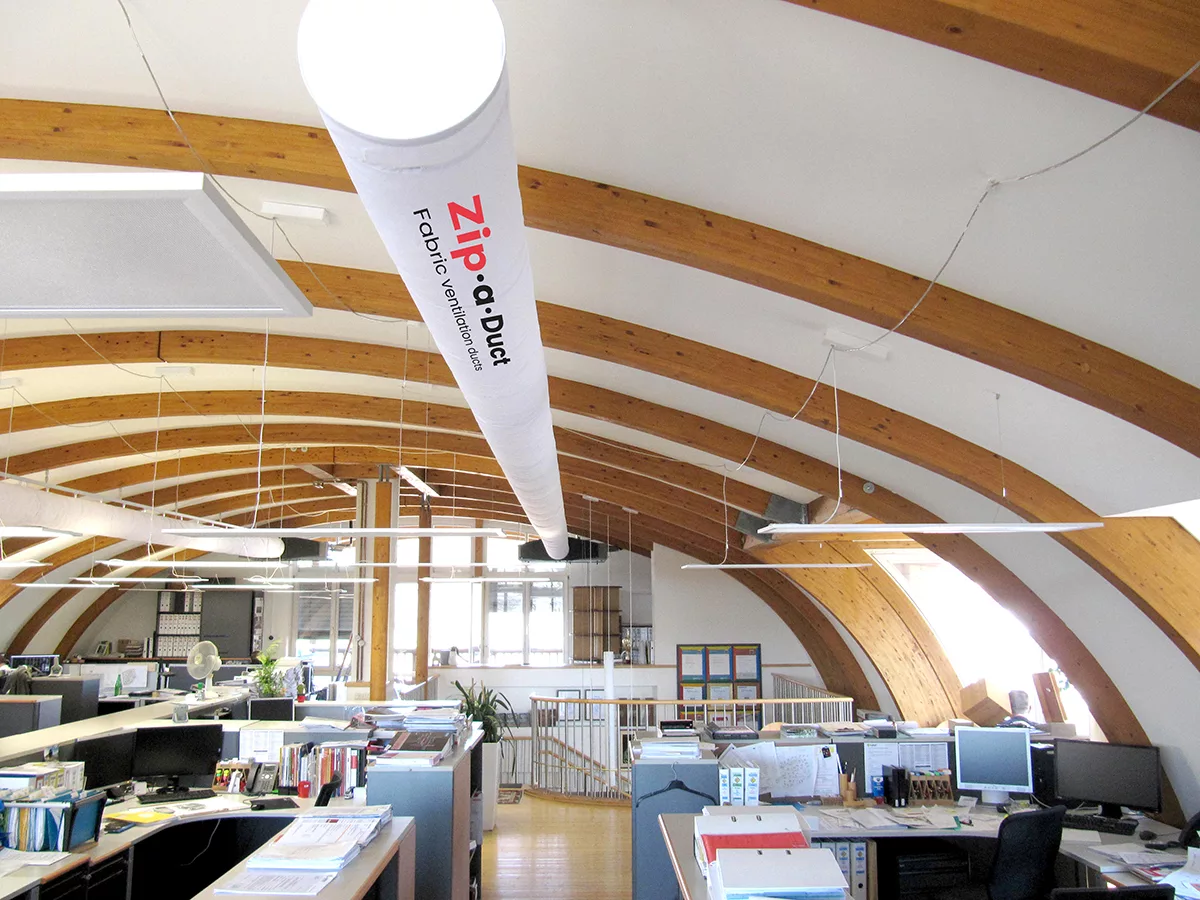 White zip-a-duct commercial duct system inside an office workspace