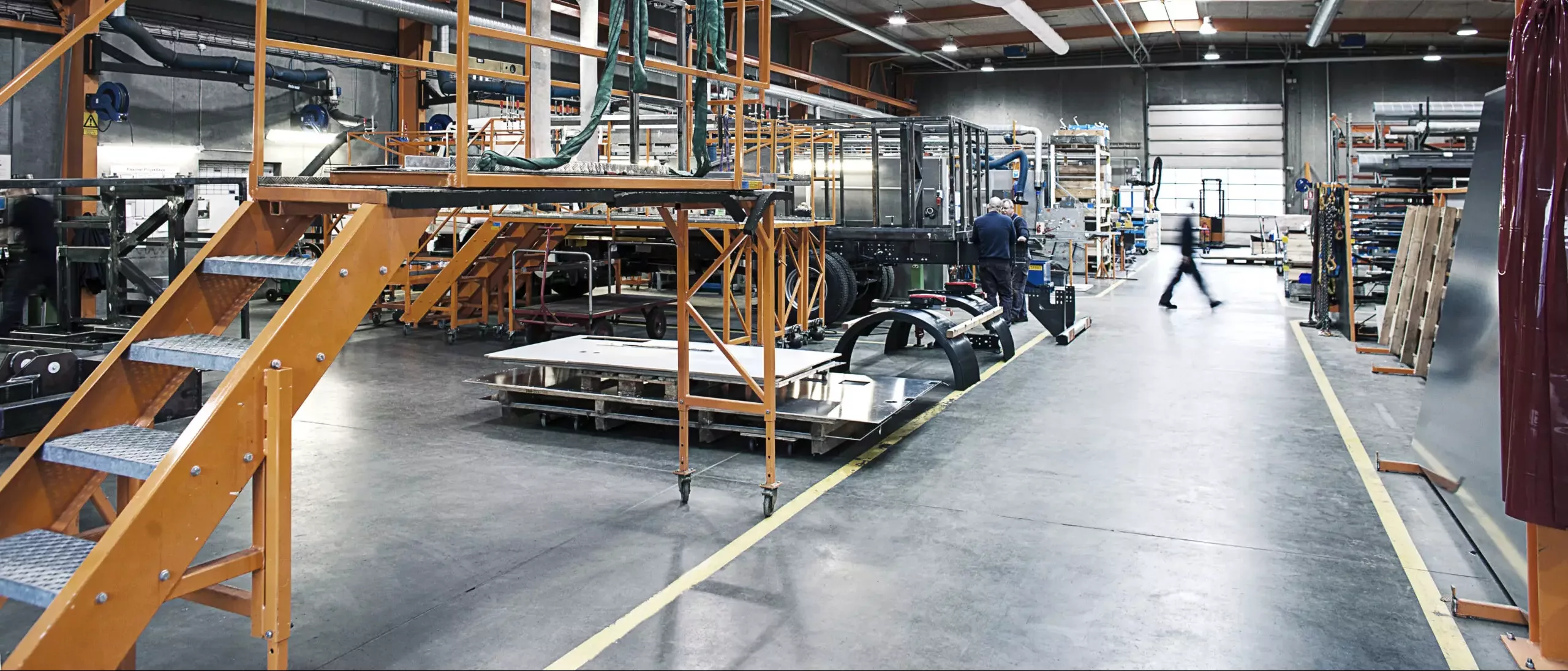 Grey zipaduct fabric ducts installed inside Vestergaard Industries factory