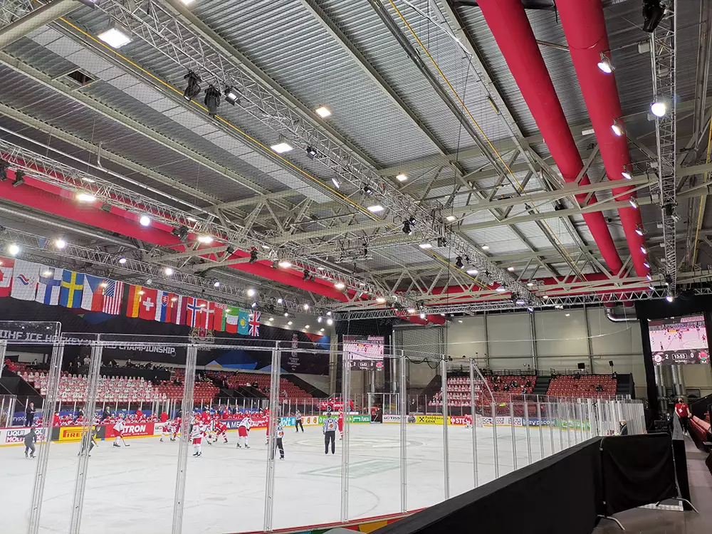 Red zipaduct fabric ducts inside an ice rink